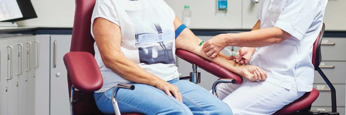 Patient in a phlebotomy chair having a blood draw